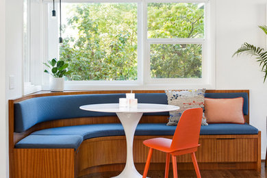 Inspiration for a mid-century modern medium tone wood floor and brown floor eat-in kitchen remodel in Portland with flat-panel cabinets, medium tone wood cabinets and an island