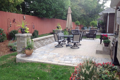 Inspiration for a mid-sized traditional backyard patio in Louisville with concrete pavers and no cover.
