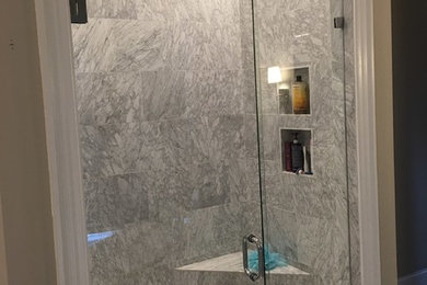 Design ideas for a bathroom in Charlotte with a double shower, porcelain tile and a hinged shower door.