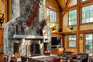 Large trendy open concept dark wood floor living room photo in Burlington with brown walls, a standard fireplace, a stone fireplace and a tv stand