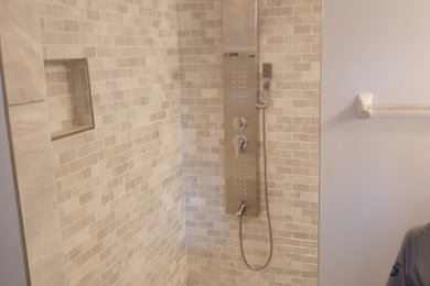 Example of a minimalist master white tile and marble tile bathroom design with a hinged shower door