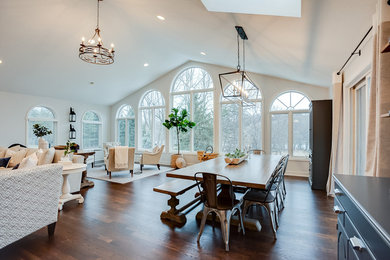 Inspiration for a large transitional dark wood floor and brown floor dining room remodel in Minneapolis with white walls, a standard fireplace and a brick fireplace