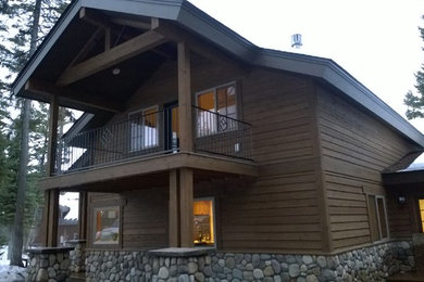 Inspiration for a large rustic brown two-story wood gable roof remodel in Other