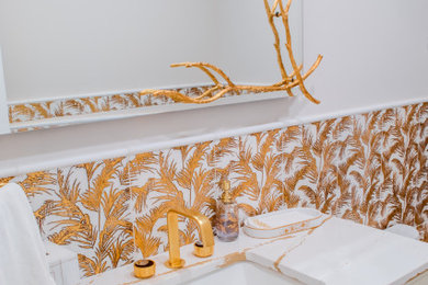 Toilet room - mid-sized transitional 3/4 white tile and porcelain tile marble floor, white floor and single-sink toilet room idea in DC Metro with flat-panel cabinets, white cabinets, a bidet, white walls, a wall-mount sink, marble countertops, white countertops and a built-in vanity