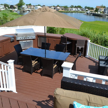 : Custom Outdoor Kitchen: A new grill, refrigerator, and smoker/cooker are set w