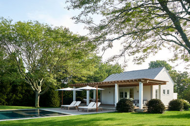 Inspiration for a coastal backyard rectangular pool house remodel in New York