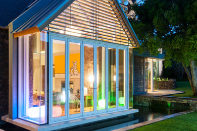 Mid-sized eclectic two-story exterior home photo in Other with a metal roof