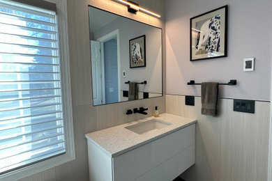 Bathroom - large modern master beige tile and stone slab porcelain tile, gray floor and double-sink bathroom idea in New York with flat-panel cabinets, white cabinets, a two-piece toilet, purple walls, an undermount sink, quartz countertops, a hinged shower door, white countertops, a niche and a floating vanity