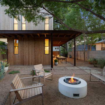 Side Perspective of Modern Fire Feature and Wood-Framed Home