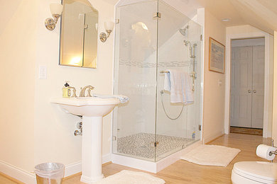 Large elegant 3/4 gray tile and ceramic tile light wood floor doorless shower photo in Other with a pedestal sink, a one-piece toilet and beige walls