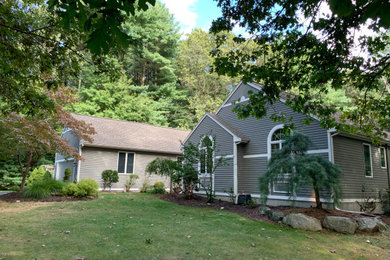 Inspiration for a mid-sized contemporary brown one-story wood exterior home remodel in Providence with a shingle roof