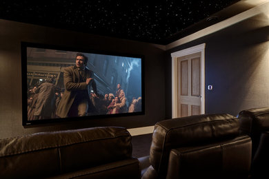 Design ideas for a modern home cinema in Kent with grey walls, carpet and black floors.