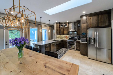 Eat-in kitchen - small cottage l-shaped ceramic tile and beige floor eat-in kitchen idea in Portland with a farmhouse sink, shaker cabinets, dark wood cabinets, granite countertops, gray backsplash, stainless steel appliances, a peninsula and mosaic tile backsplash