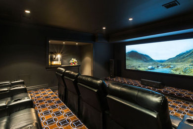 Medium sized traditional enclosed home cinema in New York with grey walls, carpet, a projector screen and orange floors.