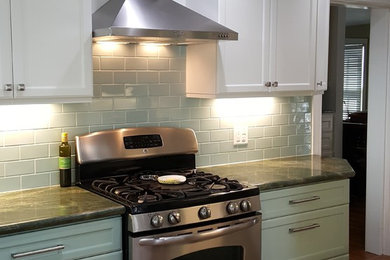 Kitchen - mid-sized country medium tone wood floor and brown floor kitchen idea in Houston with recessed-panel cabinets, white cabinets, marble countertops, blue backsplash, subway tile backsplash and stainless steel appliances