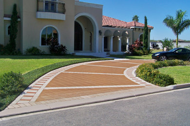 Design ideas for a large contemporary front yard brick driveway in Austin.
