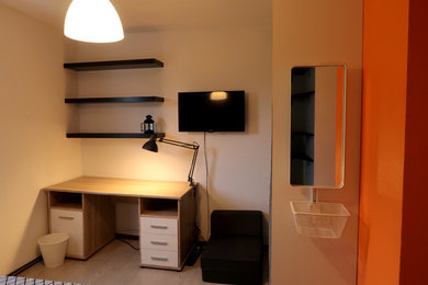 This is an example of a small modern teen’s room for boys in Other with multi-coloured walls, light hardwood flooring and beige floors.