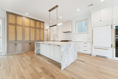 Example of a minimalist open concept kitchen design in Charleston with an undermount sink, shaker cabinets, light wood cabinets, marble countertops, white backsplash, marble backsplash, white appliances, an island and white countertops