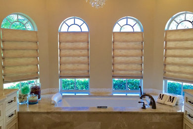 Bathroom - transitional marble floor bathroom idea with a two-piece toilet, beige walls and an undermount sink