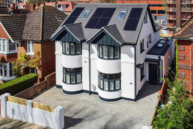 Large contemporary detached house in Sussex with three floors and metal cladding.