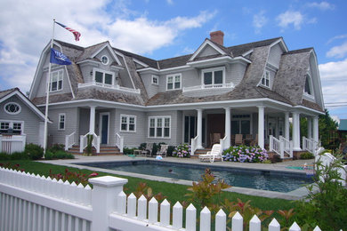 Example of a classic gray two-story wood exterior home design in New York
