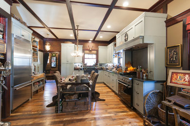 Mountain style u-shaped eat-in kitchen photo in New York with a farmhouse sink, shaker cabinets, green cabinets, soapstone countertops, green backsplash, stone slab backsplash and stainless steel appliances