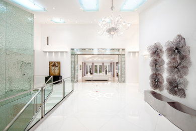 Example of a large trendy foyer design in Los Angeles with white walls