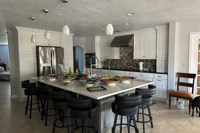 Large elegant kitchen photo in Orlando with a farmhouse sink, quartz countertops, ceramic backsplash and an island