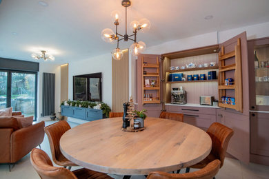 Photo of an expansive l-shaped open plan kitchen in Other with a submerged sink, shaker cabinets, pink cabinets, quartz worktops, white splashback, black appliances, ceramic flooring, an island, grey floors, white worktops and exposed beams.