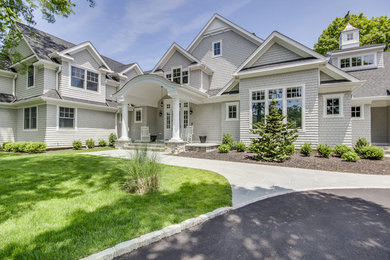 Example of a large classic gray two-story wood exterior home design in New York with a mixed material roof