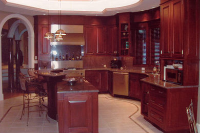Example of a huge transitional u-shaped porcelain tile, beige floor and tray ceiling eat-in kitchen design in Boston with a single-bowl sink, raised-panel cabinets, dark wood cabinets, granite countertops, multicolored backsplash, granite backsplash, stainless steel appliances, an island and multicolored countertops