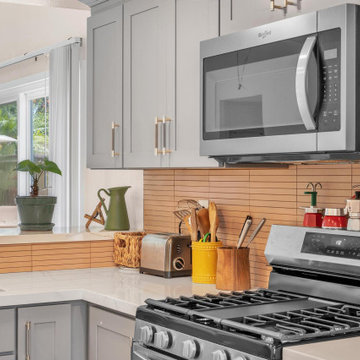 Warm Contemporary Kitchen Remodel in Dana Point with Linear Backsplash Accents