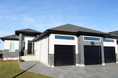 Mid-sized contemporary multicolored one-story mixed siding exterior home idea in Other with a hip roof