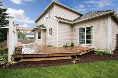 Mid-sized arts and crafts backyard deck photo in Minneapolis with a pergola
