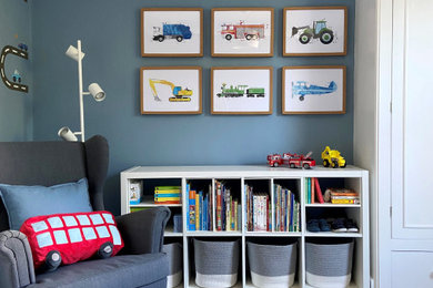 Inspiration for a toddler’s room for boys in London with blue walls, carpet and grey floors.