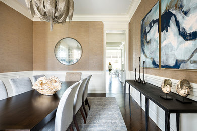 This is an example of a transitional separate dining room in Chicago with brown walls, dark hardwood floors and brown floor.