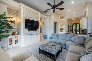Inspiration for a mid-sized transitional open concept living room in Tampa with beige walls, porcelain floors, a wall-mounted tv and beige floor.