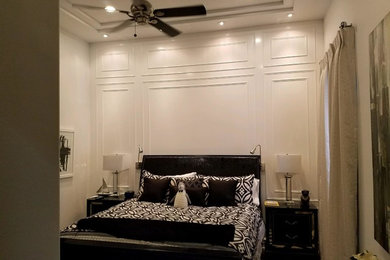 Example of a large transitional guest dark wood floor and brown floor bedroom design in Other with white walls and no fireplace