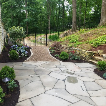 Backyard irregular patio with pergola and lighting