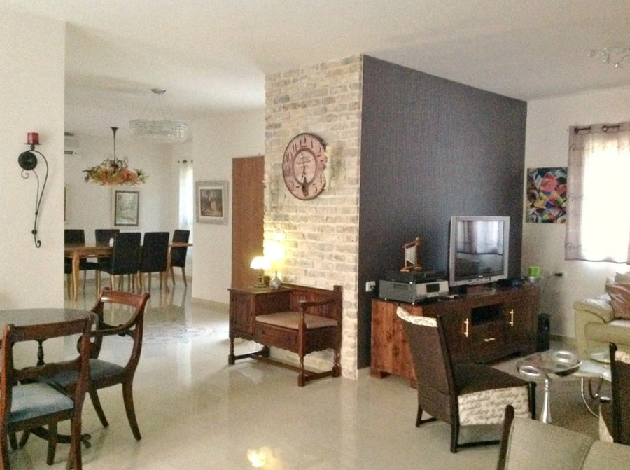 overview of entrance door/ tv area and part of dining area