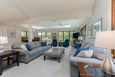 Photo of a large traditional open concept family room in Milwaukee with grey walls, carpet, a freestanding tv and grey floor.