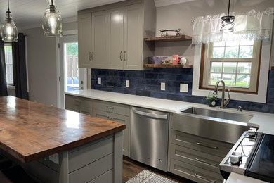 Example of a mid-sized farmhouse l-shaped kitchen design in Columbus with shaker cabinets, gray cabinets, wood countertops and two islands