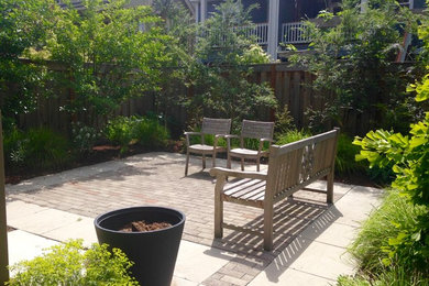 Photo of a small contemporary backyard full sun xeriscape in Portland with concrete pavers.
