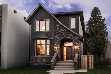 Mid-sized traditional gray two-story stucco exterior home idea in Calgary