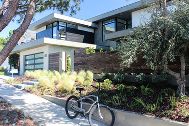Large contemporary two-story mixed siding flat roof idea in Orange County