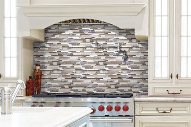 Inspiration for a timeless kitchen remodel in New York with an undermount sink, beaded inset cabinets, white cabinets, multicolored backsplash, matchstick tile backsplash and an island