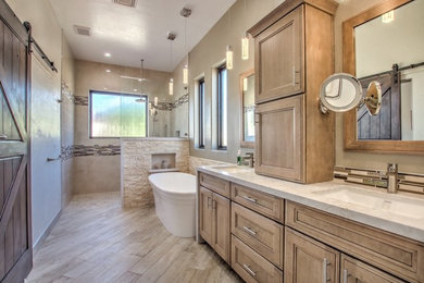Large contemporary master bathroom in Phoenix with recessed-panel cabinets, light wood cabinets, a freestanding tub, a curbless shower, a two-piece toilet, beige tile, porcelain tile, beige walls, porcelain floors, an undermount sink, engineered quartz benchtops, beige floor, an open shower and beige benchtops.