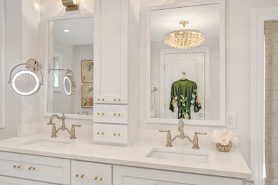 Example of a mid-sized transitional master porcelain tile, multicolored floor and double-sink bathroom design in Boston with flat-panel cabinets, white cabinets, an undermount tub, a two-piece toilet, white walls, an undermount sink, quartz countertops, a hinged shower door, white countertops, a niche and a built-in vanity