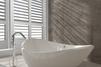 Design ideas for a mid-sized contemporary bathroom in Newcastle - Maitland with a freestanding tub, ceramic tile, ceramic floors and beige floor.