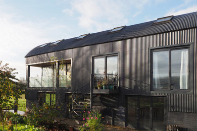 Design ideas for a large and blue rustic side detached house with three floors, metal cladding, a metal roof and a blue roof.